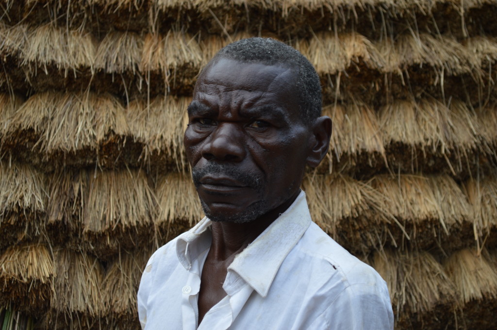 Rwandan man near traditional hut